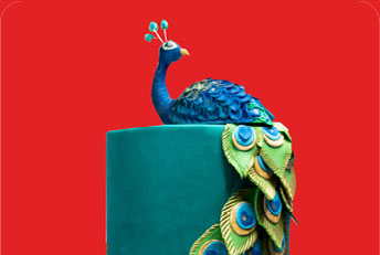 A stunning peacock-themed cake from Kabhi B, featuring intricate detailing and vibrant colors